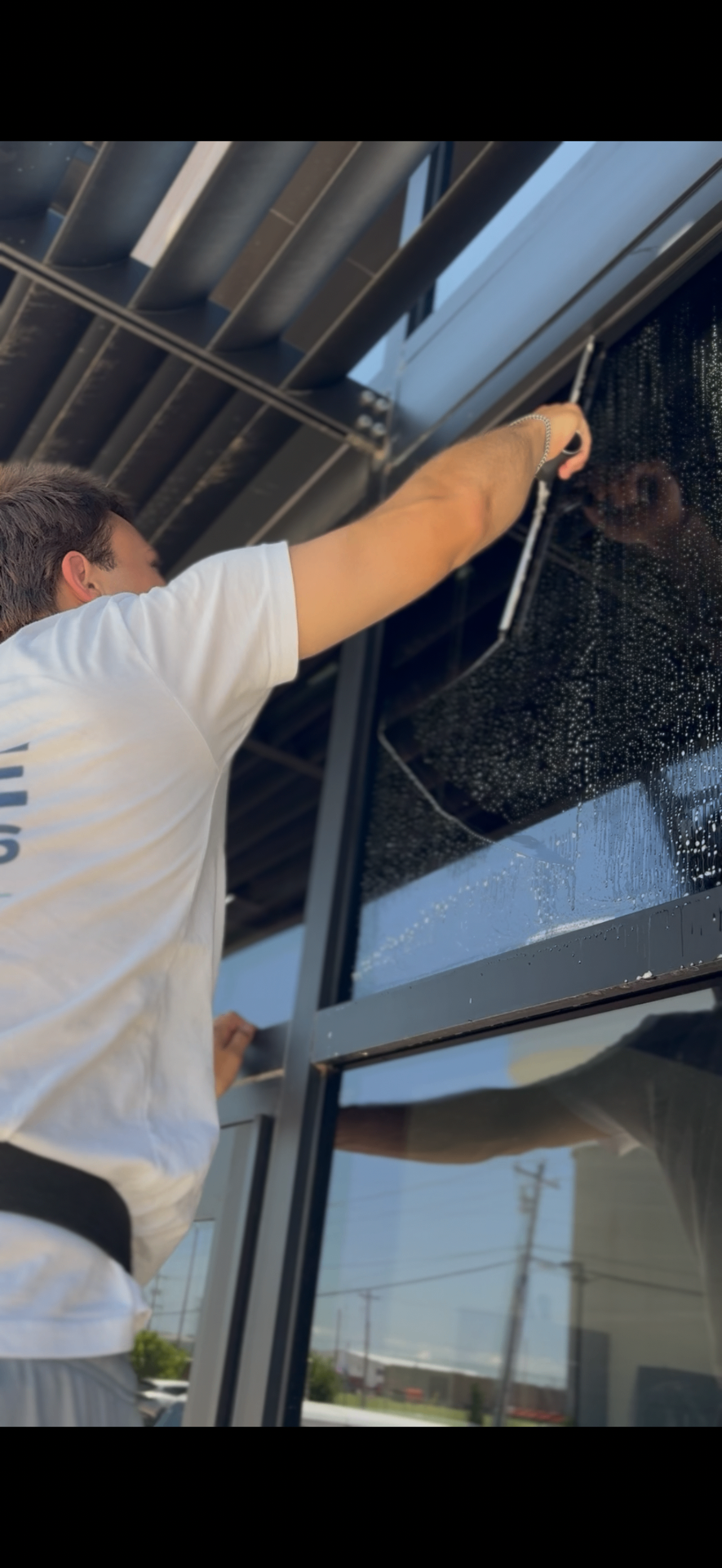 Detailed squeegee work on a commercial window